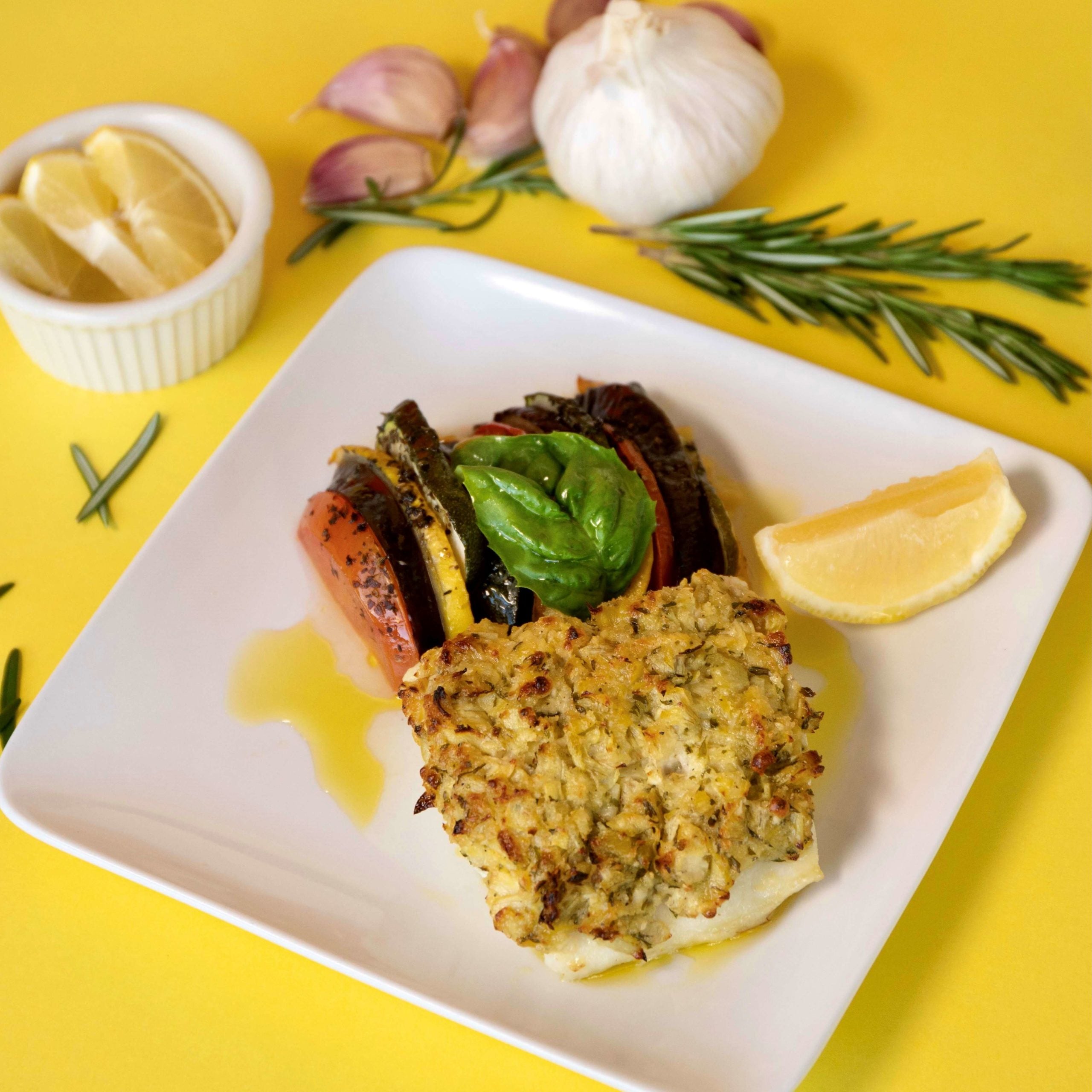 breaded crispy salmon on white plate served with cheese cole slaw and lemon slice