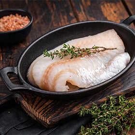 A pristine raw cod fillet, waiting to be marinated and cooked to perfection.