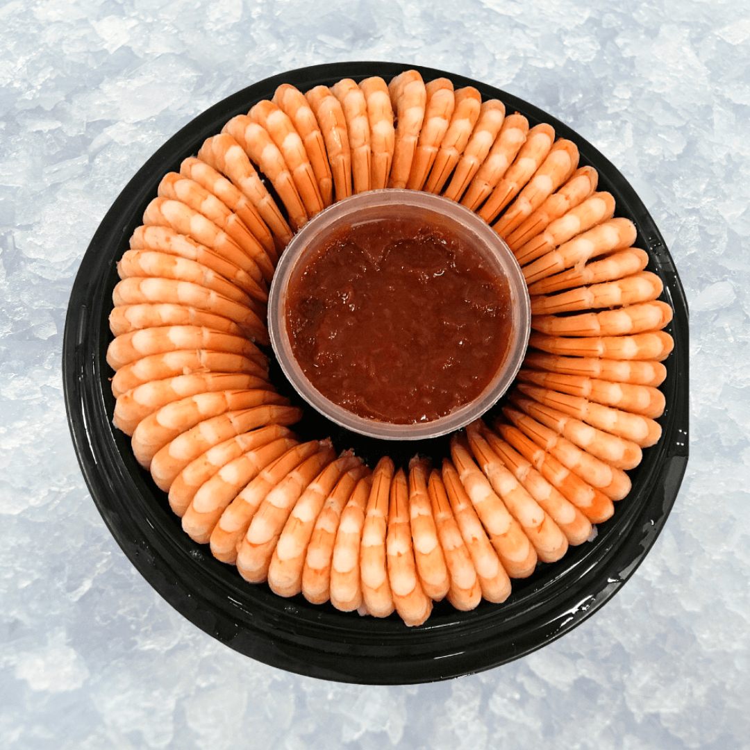 full shrimp ring with cocktail sauce opened on a bed of ice