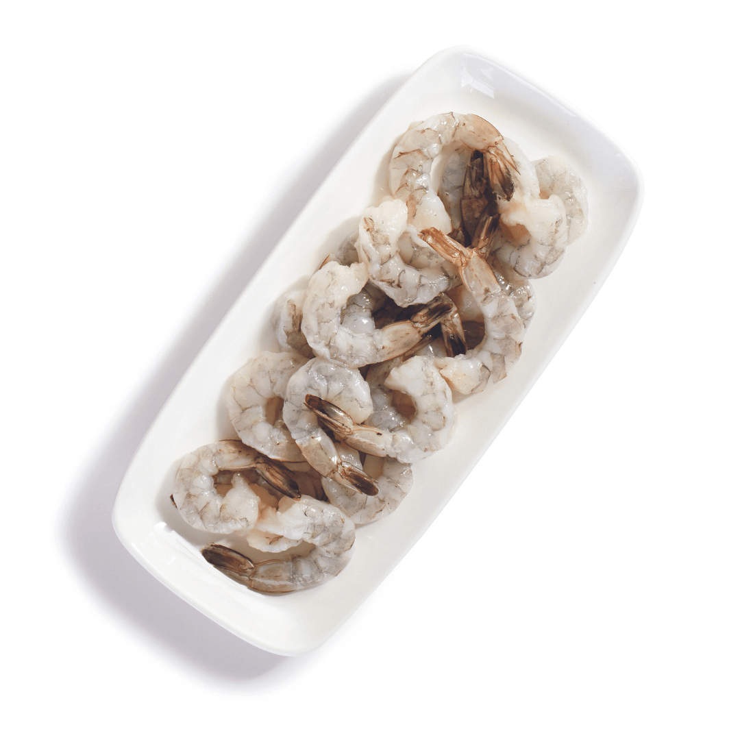 plate of peeled raw shrimp with tails on