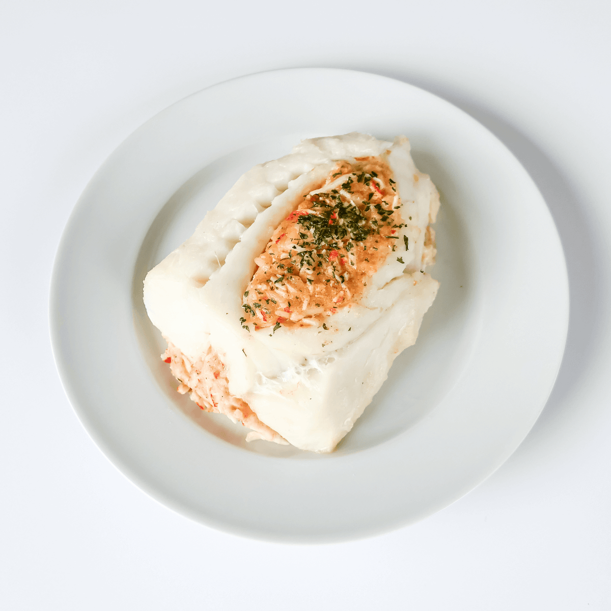 baked stuffed cod on a white plate