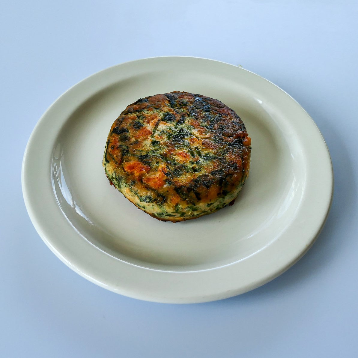 cooked salmon kelp burger on a white plate