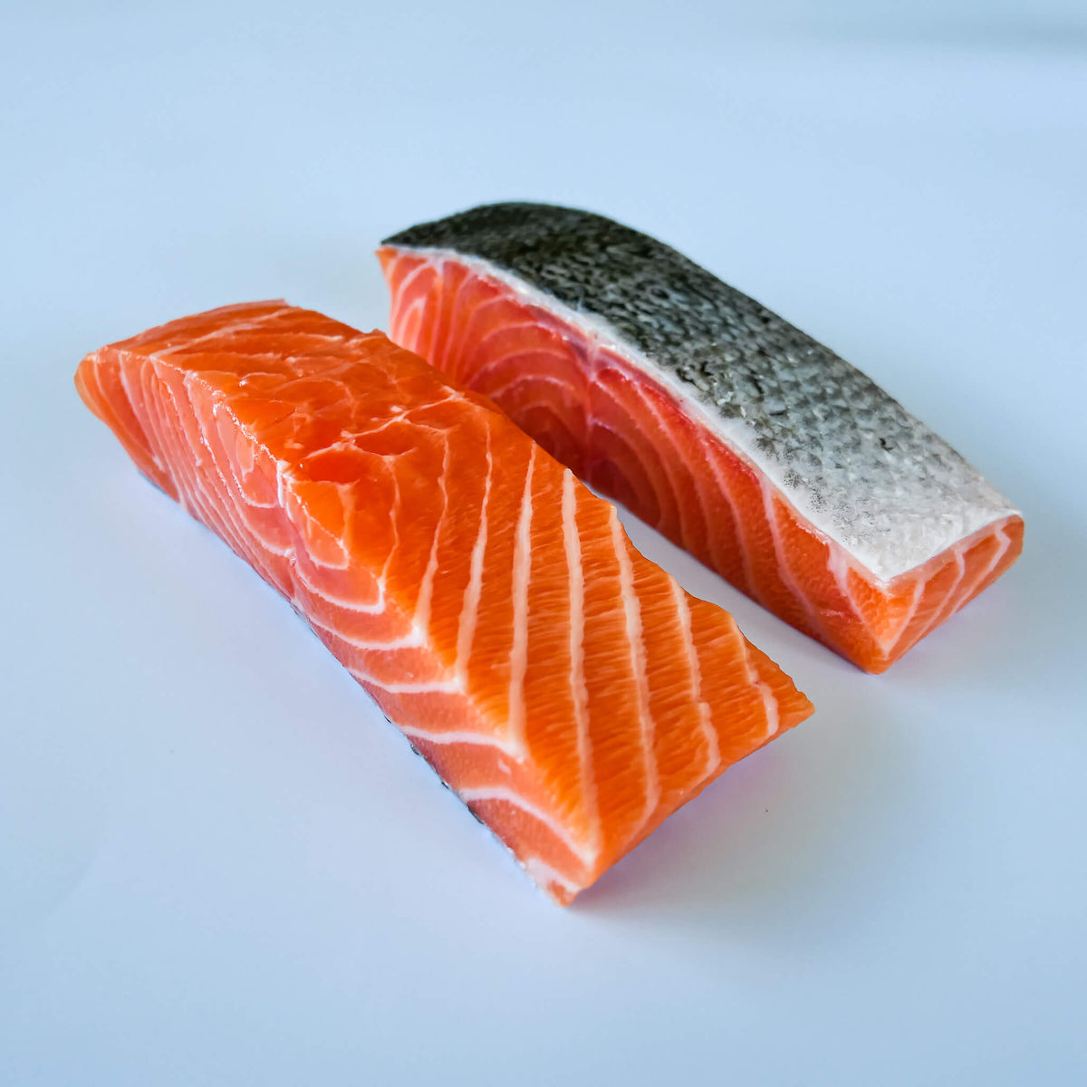 fresh salmon portions on a white background