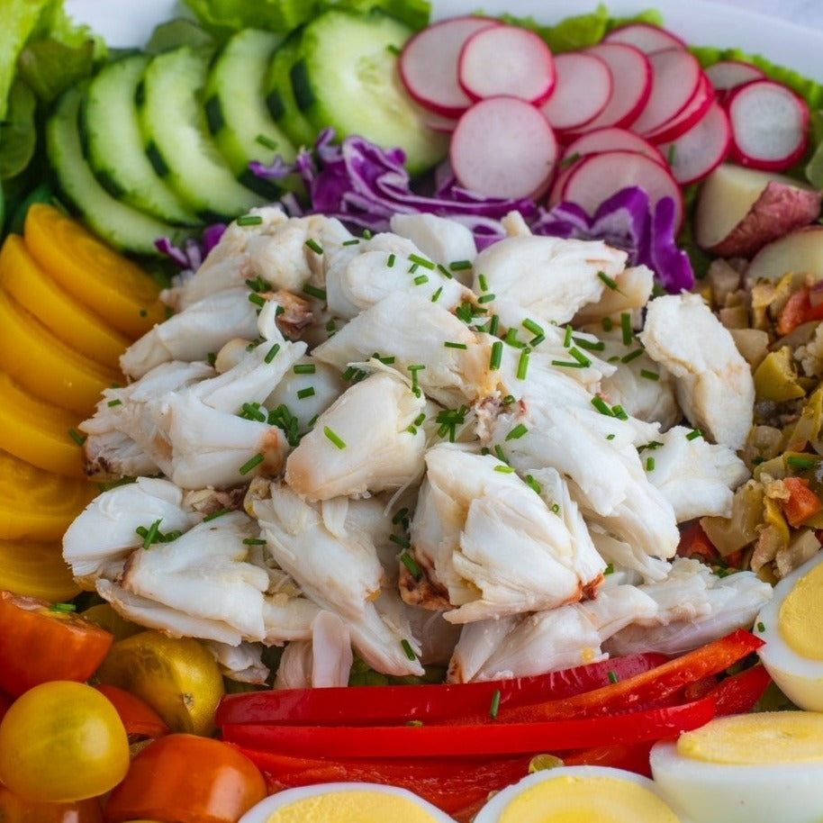 jumbo lump crab meat salad with fresh vegetables and hard boiled eggs