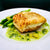 6 ounce portion of fresh halibut with lemon and parsley in the background