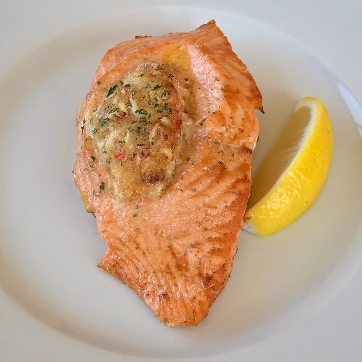 baked stuffed salmon on a white plate